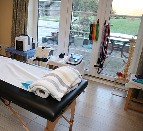 massage therapy room with treatment table towels and equipment in a bright setting ideal for relaxation and recovery 2 treatments available